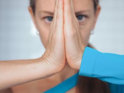 A person focusing intently while holding a challenging yoga pose.